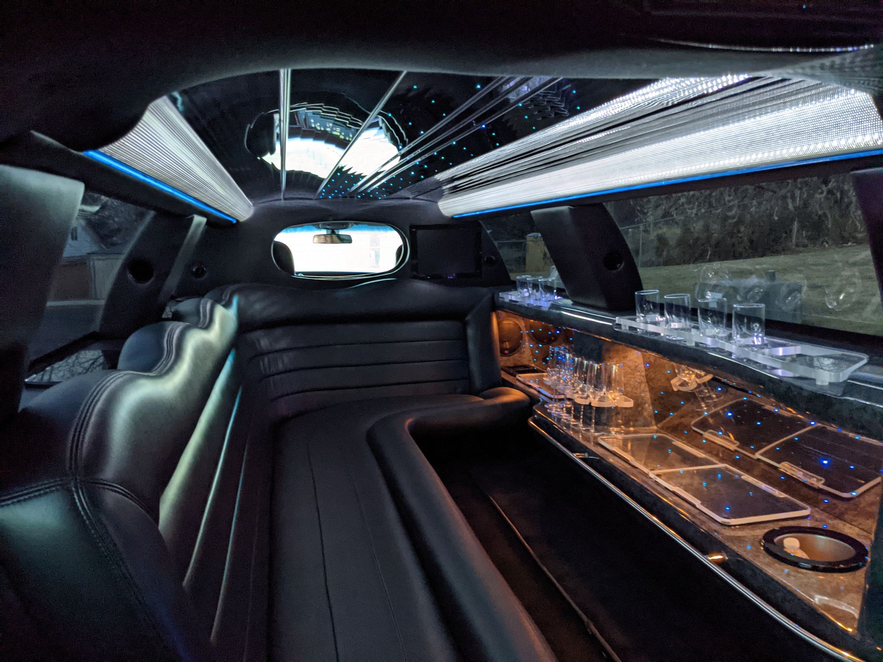 Black leather stretch limousine interior with ambient lighting