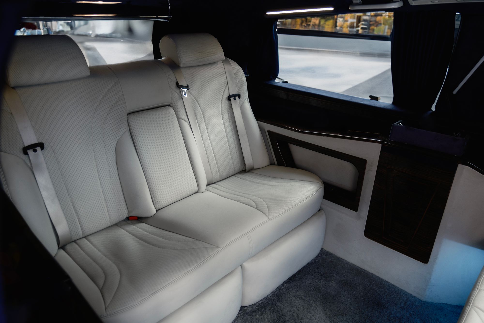 Private limousine cabin with white leather seating